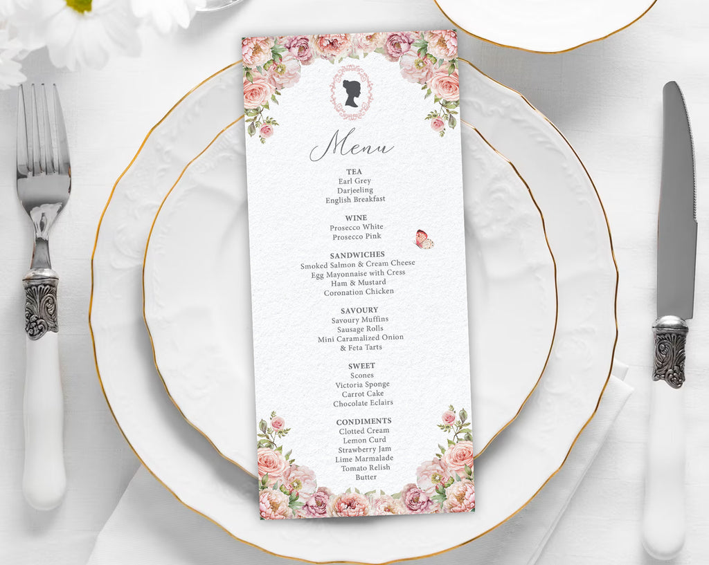 Menu card with pink floral design on a white plate with gold rim and silverware.
