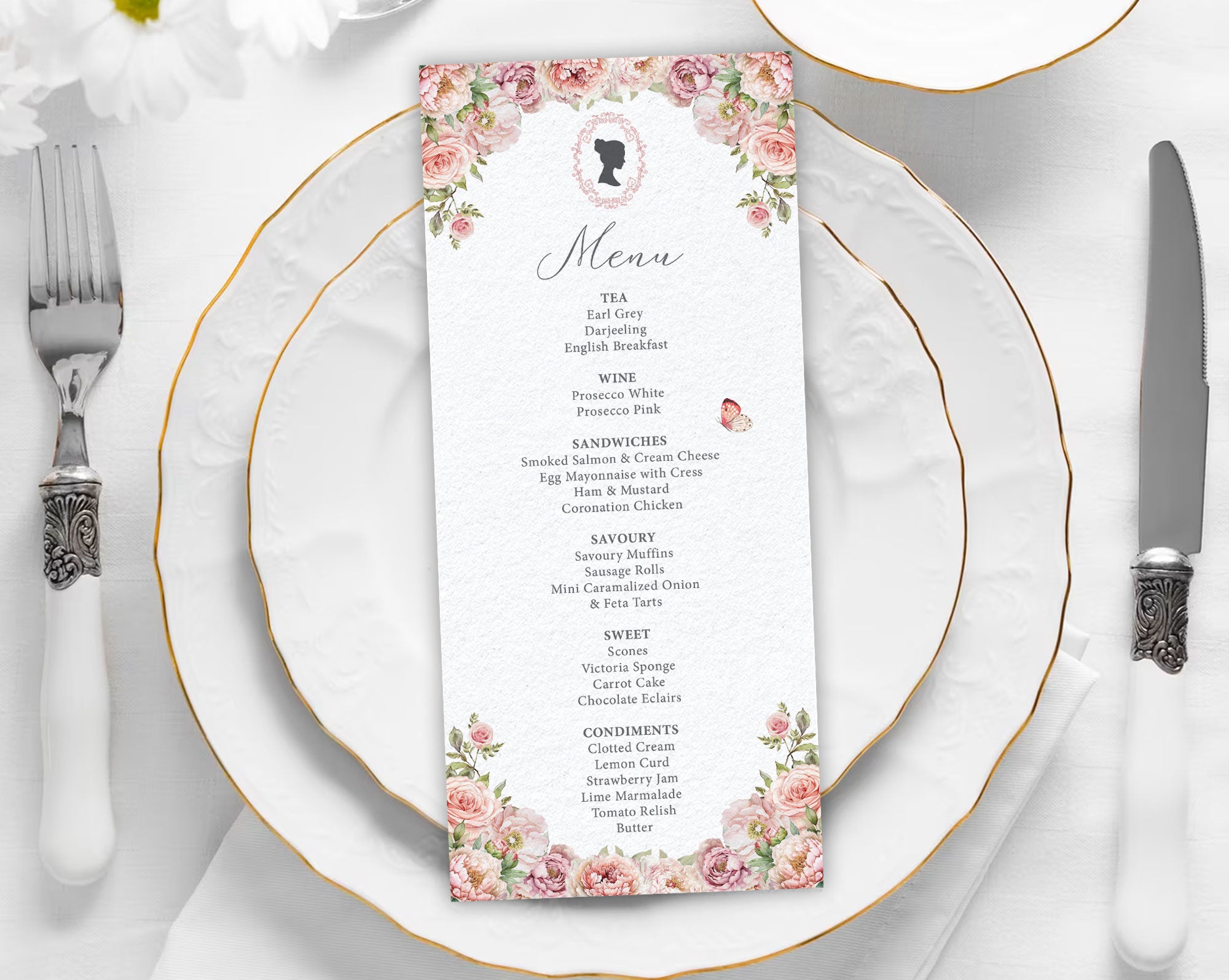 Menu card with pink floral design on a white plate with gold rim and silverware.