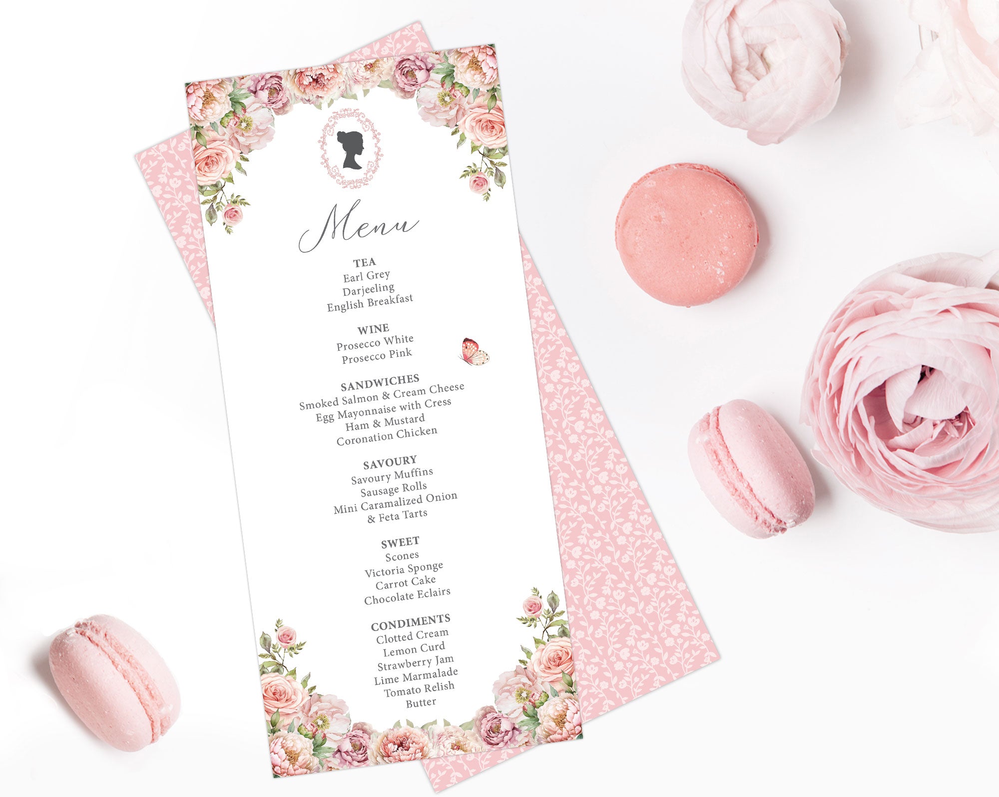 blush pink flower Menu card with cameo design, pink pattern back on a white surface with pink macarons and flowers.