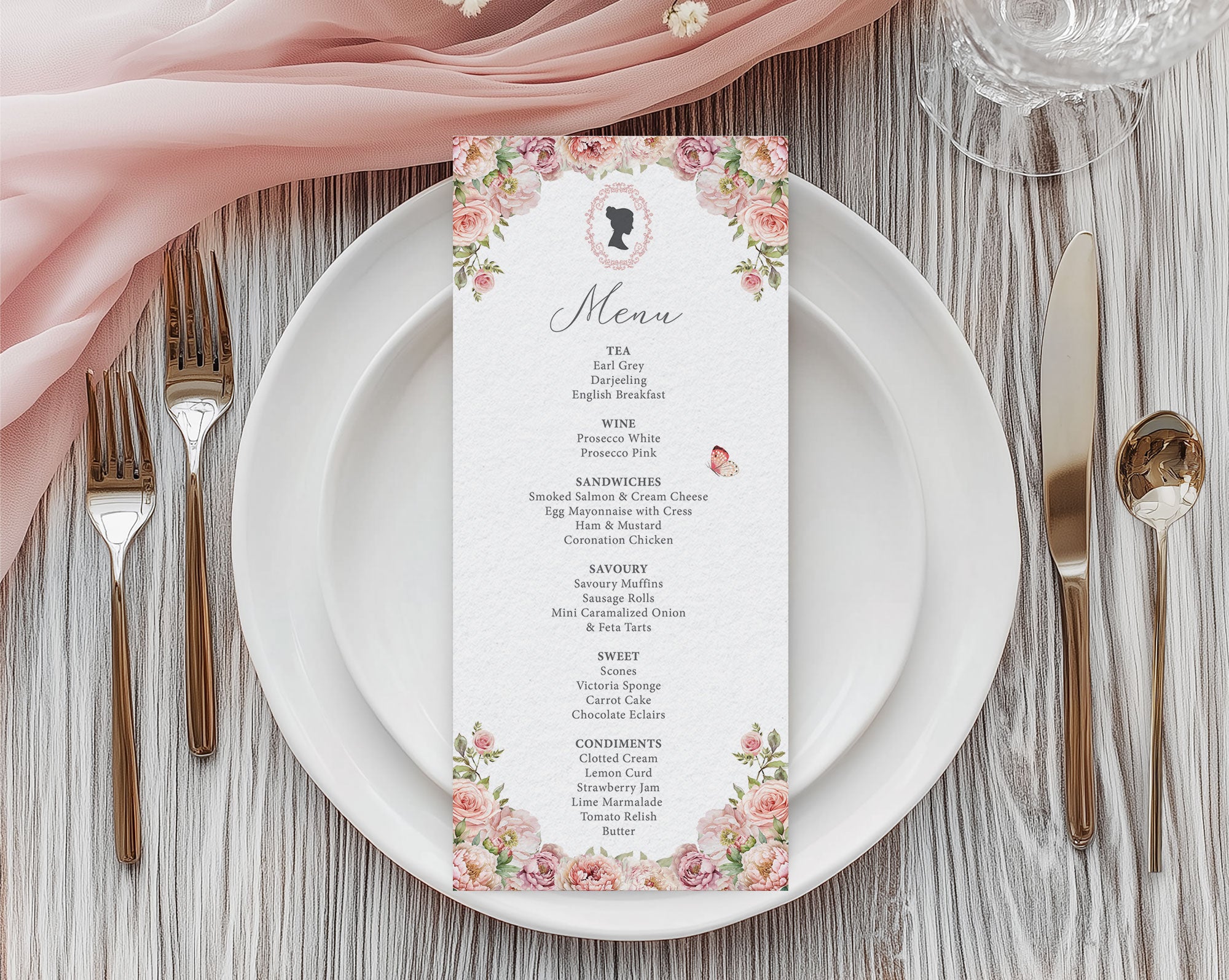 Menu card with blush pink floral and cameo design on a white plate with cutlery