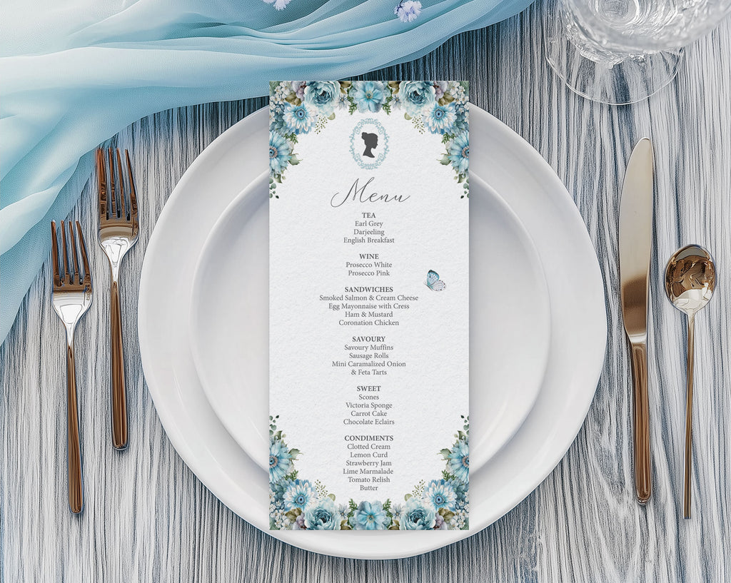 Regency Tea Party Menu with Dusty Blue Flowers, Cameo & Butterfly laying on a white plate with cutlery