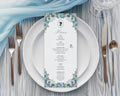 Regency Tea Party Menu with Dusty Blue Flowers, Cameo & Butterfly laying on a white plate with cutlery