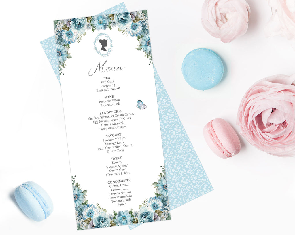a dusty blue flower regency style tea menu with a cameo lying on a white background next to macarons