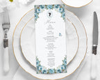 dusty blue flower, regency style menu laying on a white plate with cutlery