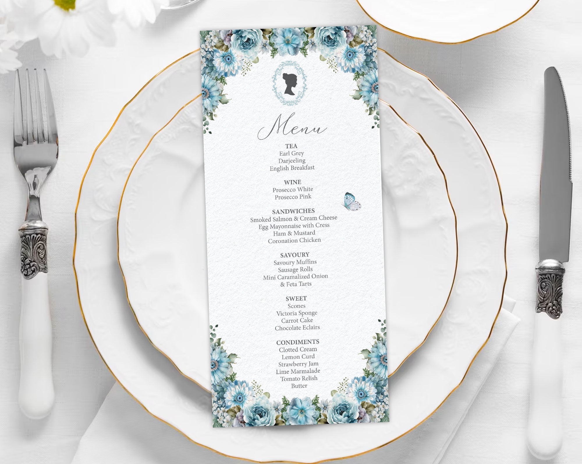 dusty blue flower, regency style menu laying on a white plate with cutlery