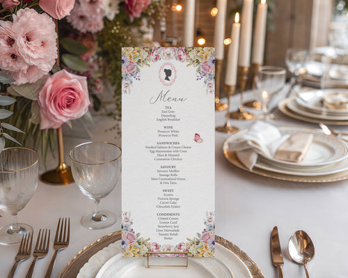 Floral menu card on a elegantly set table with pink roses and candles.