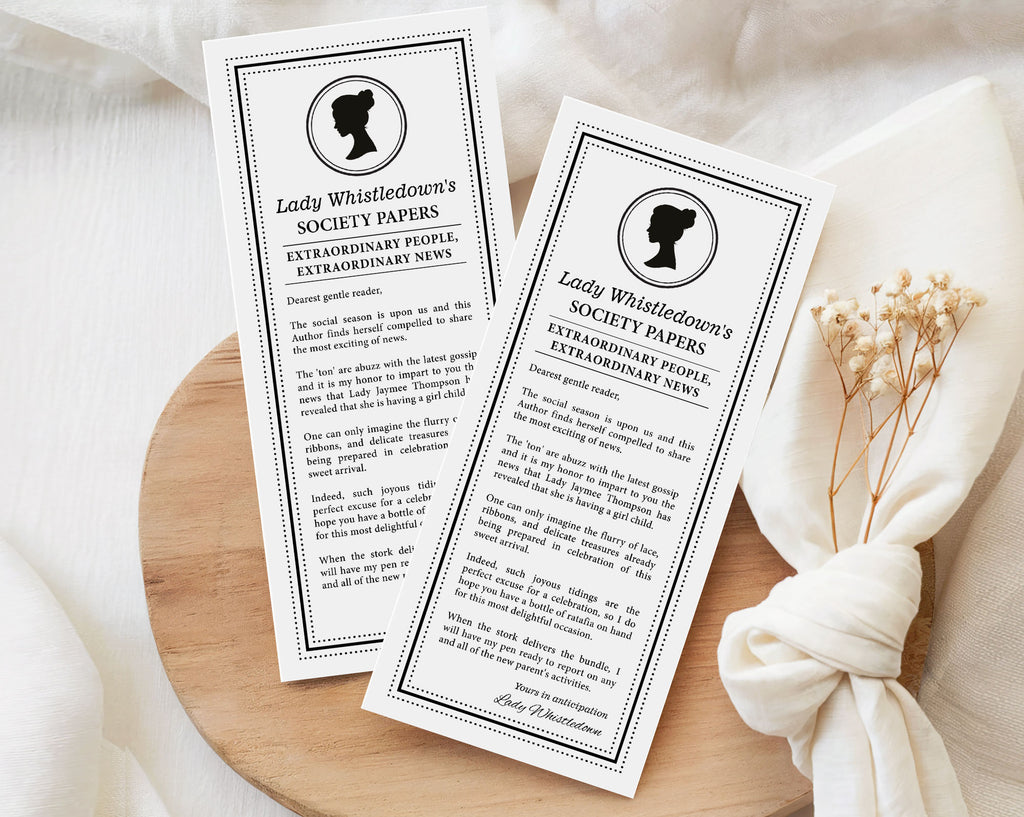 Two baby shower pregnancy reveal printed pages titled 'Lady Whistledown's Society Papers' on a wooden surface with a white cloth and dried flowers.