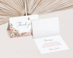 Floral thank you card with another card open to reveal text inside on a neutral background