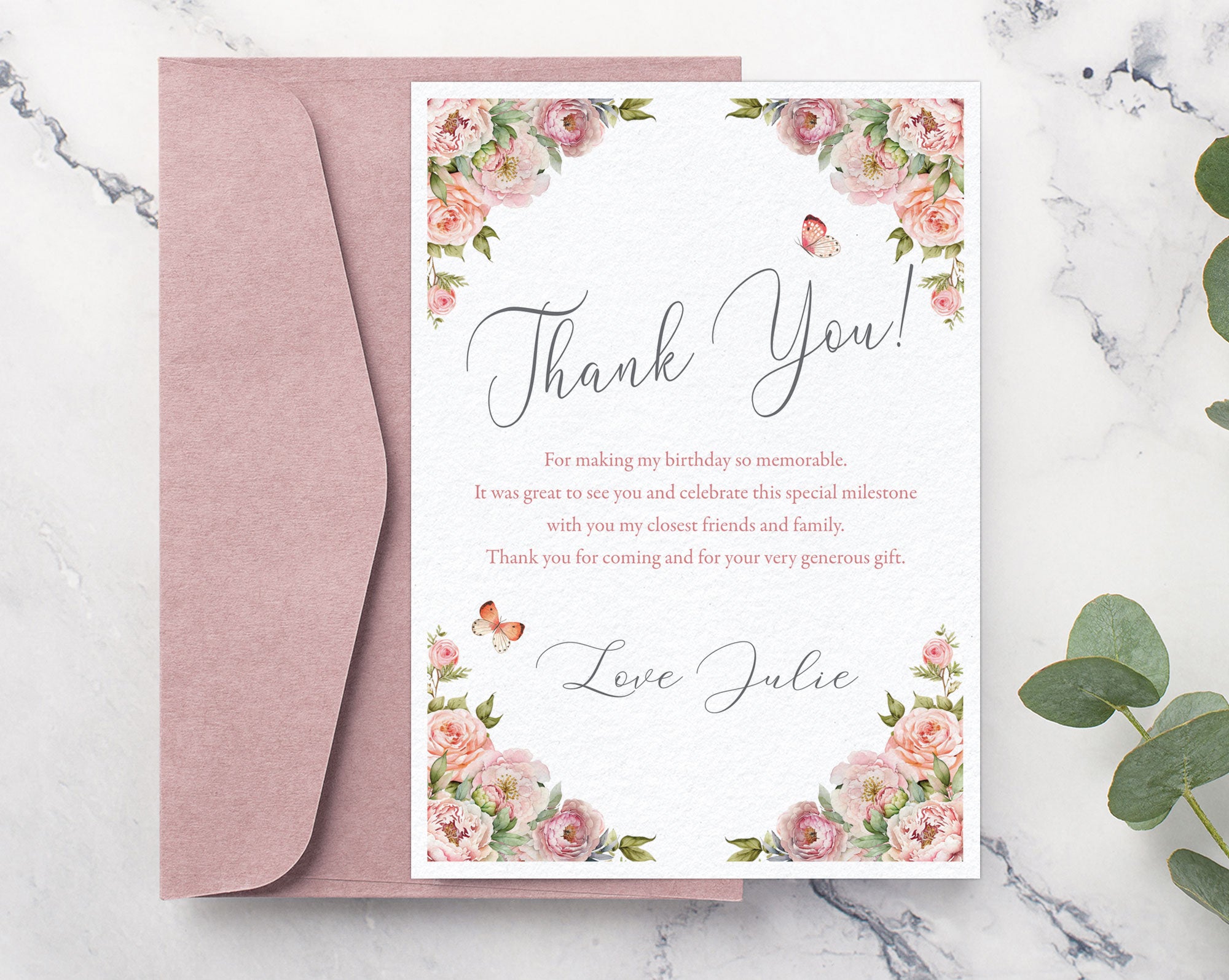 Floral thank you card with pink envelope on a marble surface