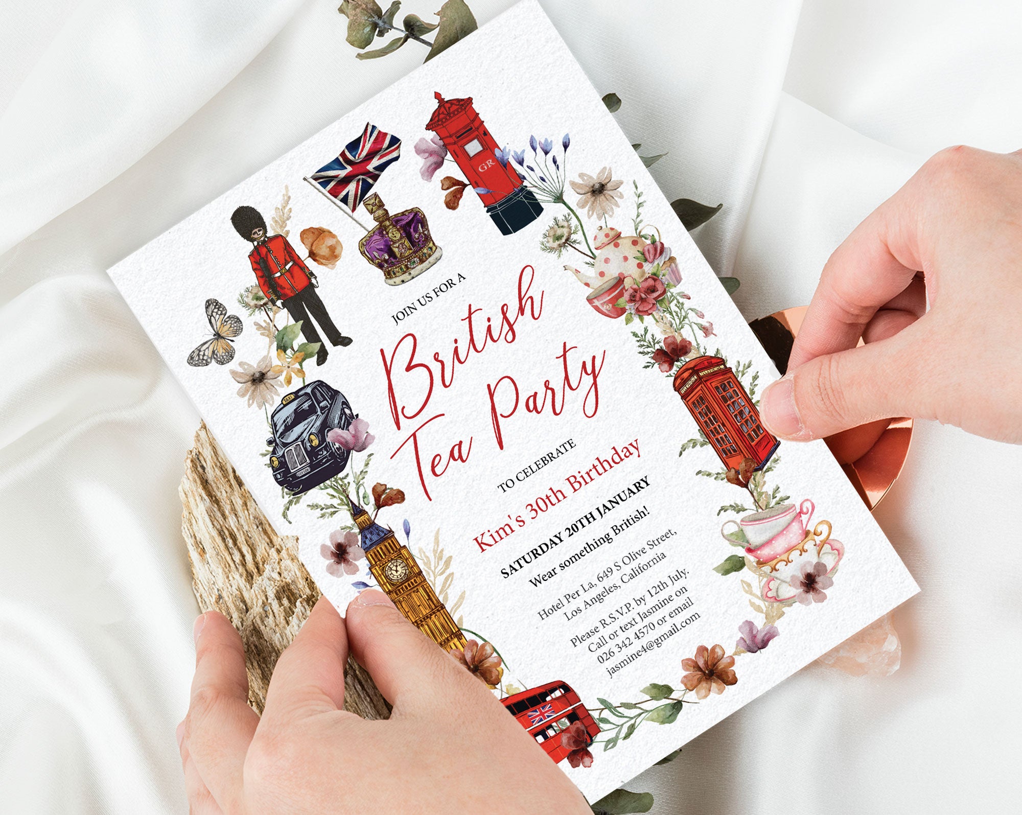 Invitation card for a British Tea Party held by hands on a white background