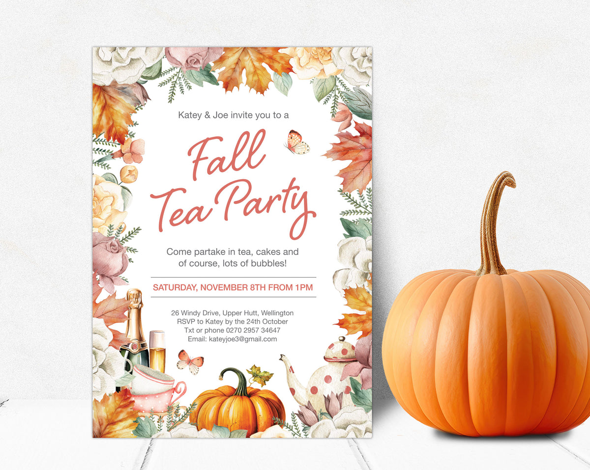 A vertical fall tea party invitation card with autumn floral illustrations and a pumpkin, placed beside a whole orange pumpkin on a light neutral background.