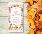 A smartphone mockup displays a fall tea party invitation with floral and autumn-themed graphics, placed on a light wood surface next to scattered orange and yellow leaves.