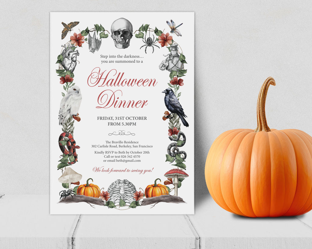 A Halloween dinner invitation card displayed on a light gray surface next to a whole orange pumpkin. The invitation features a white background with a decorative border of skulls, crows, spiders, bats, mushrooms, and pumpkins, with the text 'Halloween Dinner' in a large red script font.