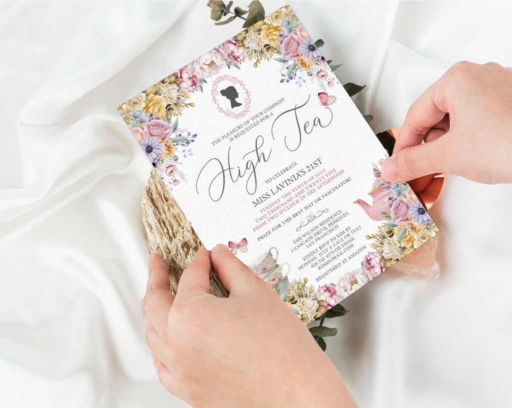 Regency Style Floral invitation card held by hands on a white fabric background