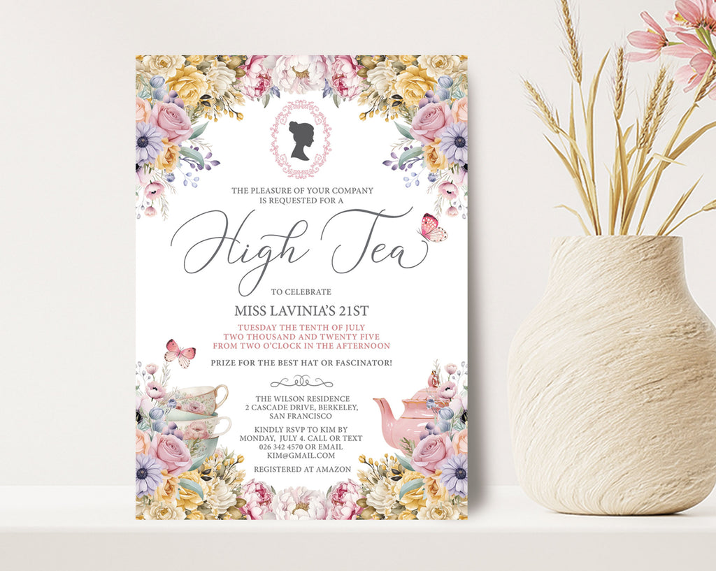 High tea invitation with floral design on a white surface next to a vase with flowers.