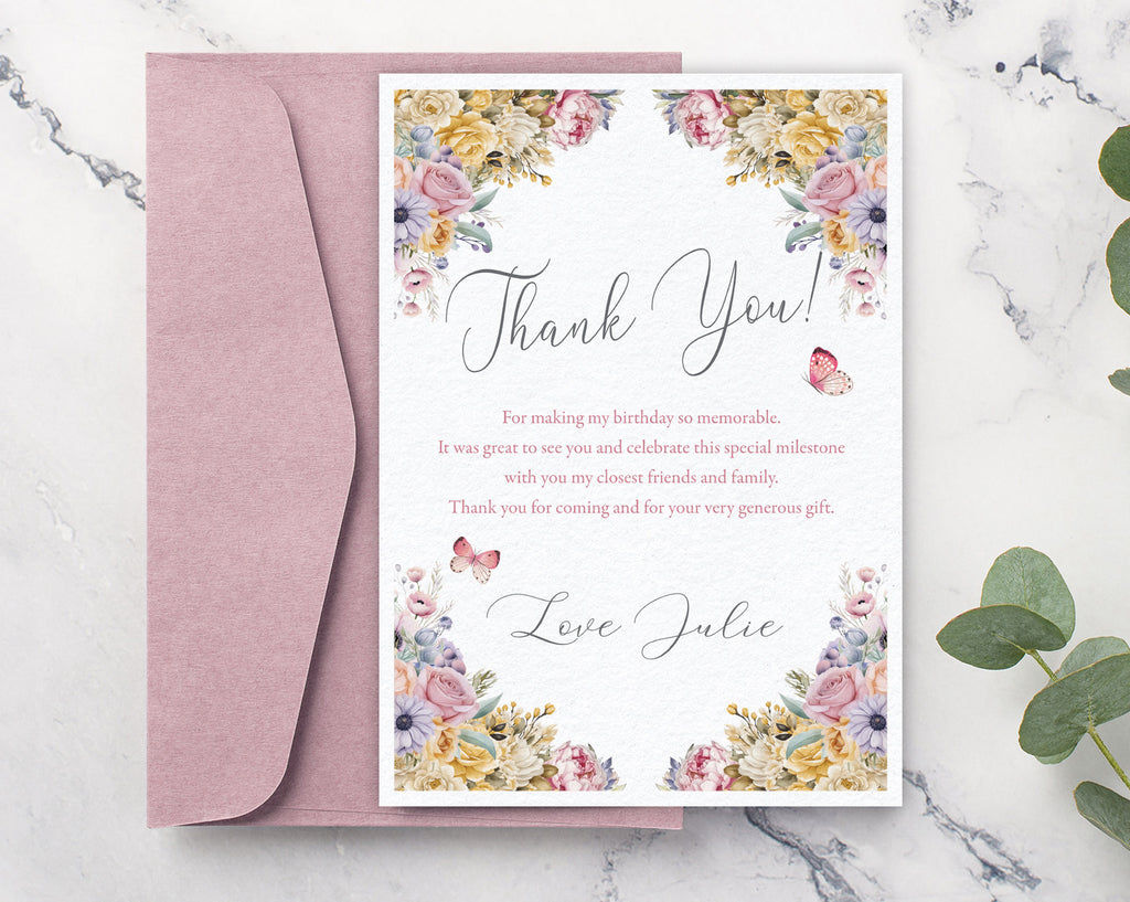Floral thank you card with pink envelope on a marble surface