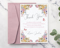 Floral thank you card with pink envelope on a marble surface