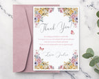 Floral thank you card with pink envelope on a marble surface