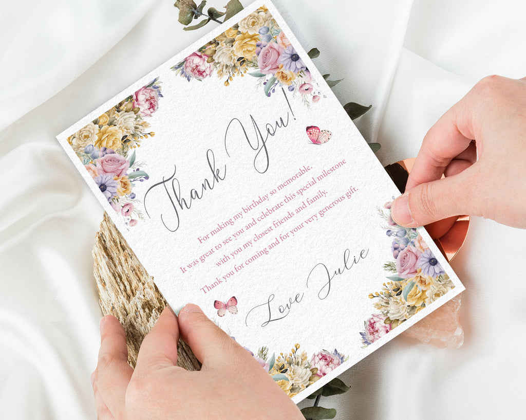 Floral thank you card held by hands on a light background