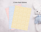 Three different colored invite backs next to a white stuffed animal toy on a light gray background.