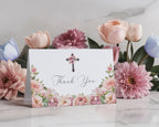 Floral card with 'Thank You' message inside and christian cross in front of flowers on a marble surface