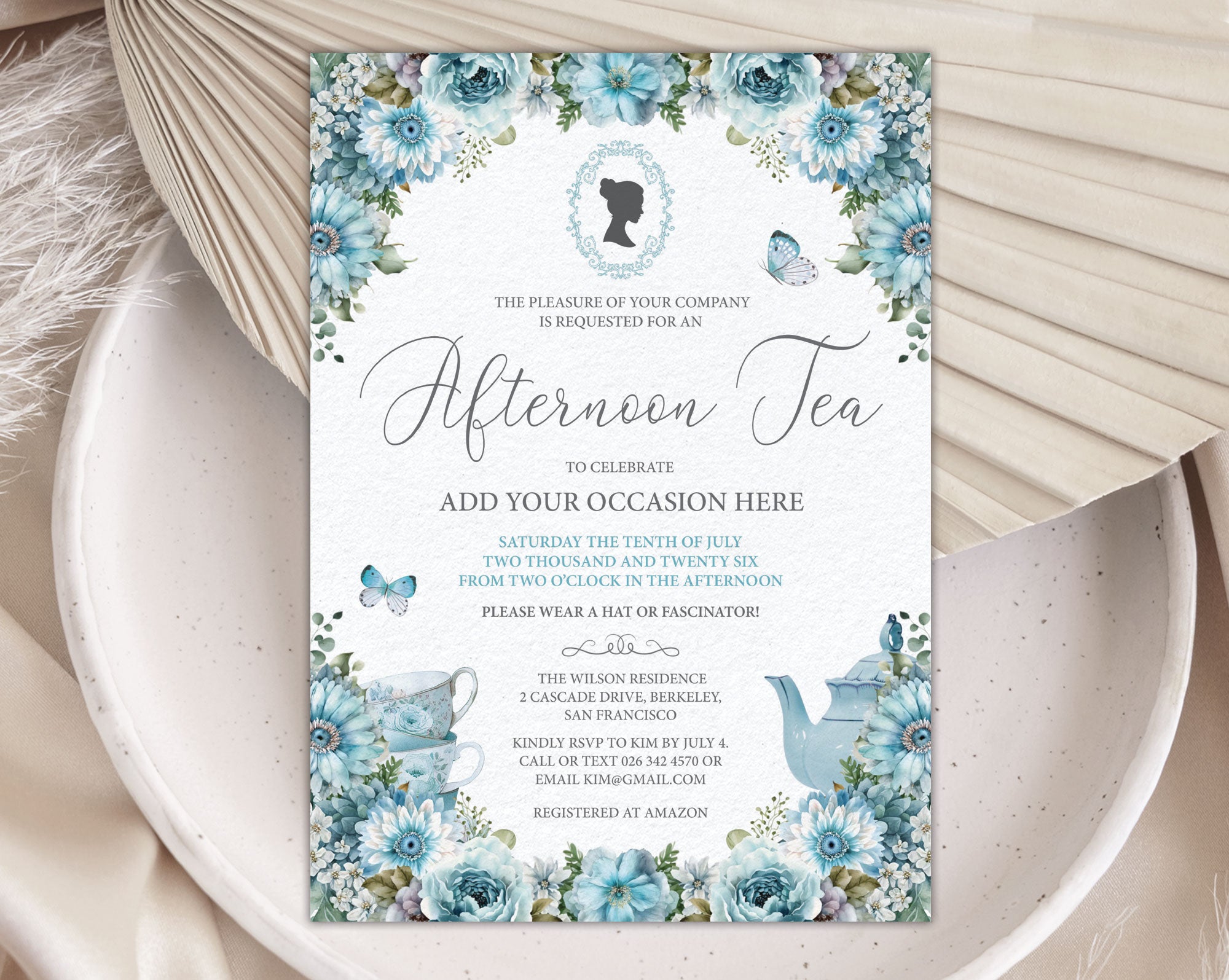 dusty blue Invitation card for an afternoon tea event with floral design, cameo and teapot on a textured surface