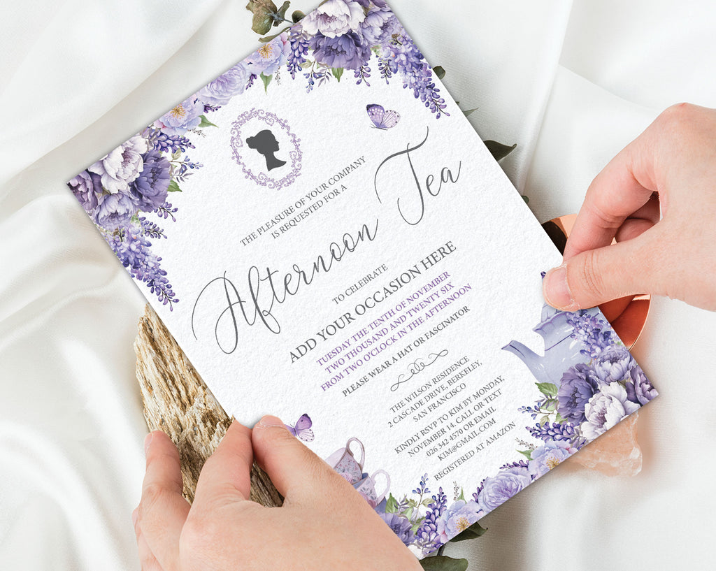 A floral tea invitation card being held by two hands over a white satin fabric background with dried flowers. The card features purple lavender illustrations, elegant black script text, and a silhouette portrait frame at the top.