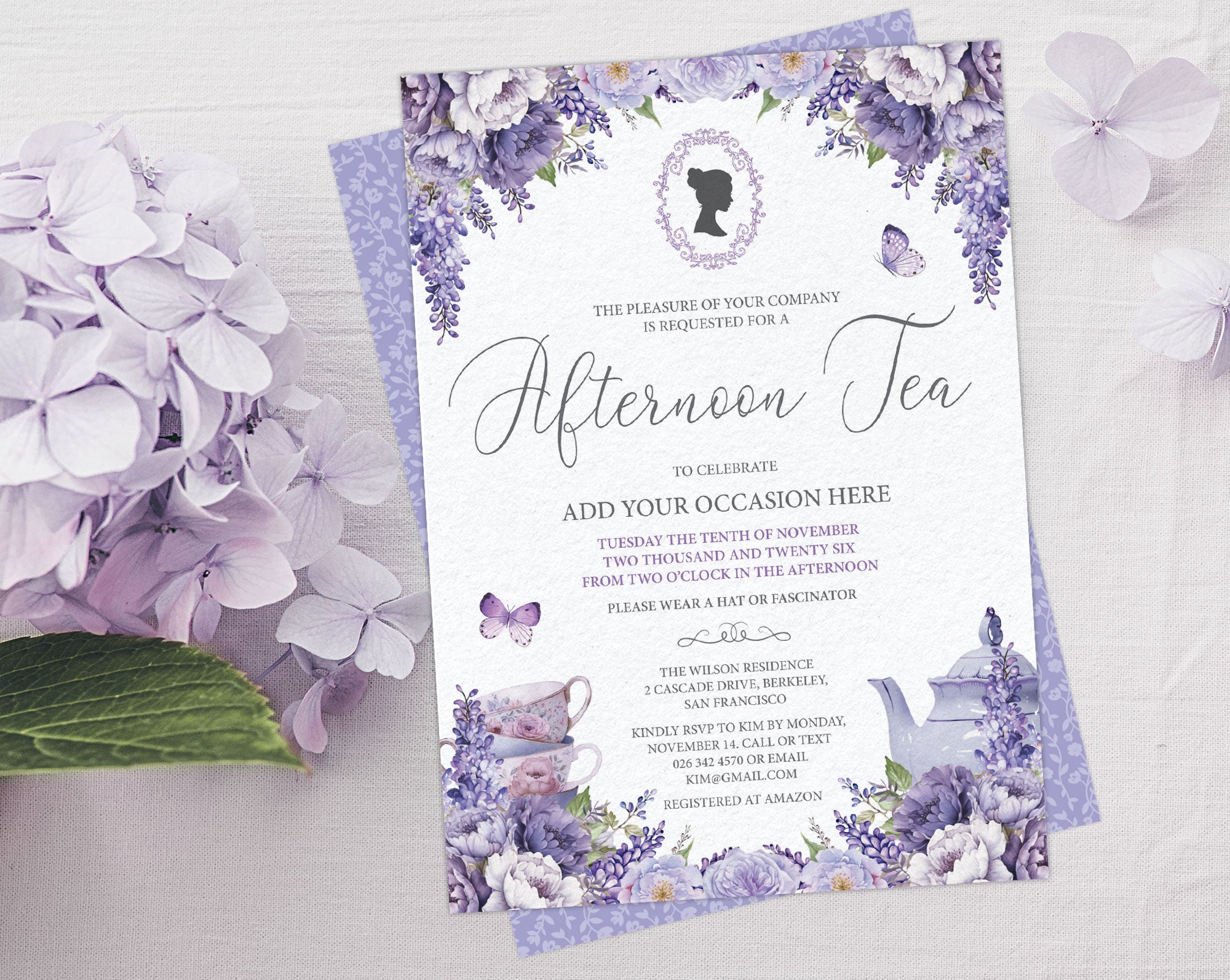 A floral afternoon tea invitation card with purple lavender and white flowers, styled on a white textured surface with matching purple hydrangea flowers.