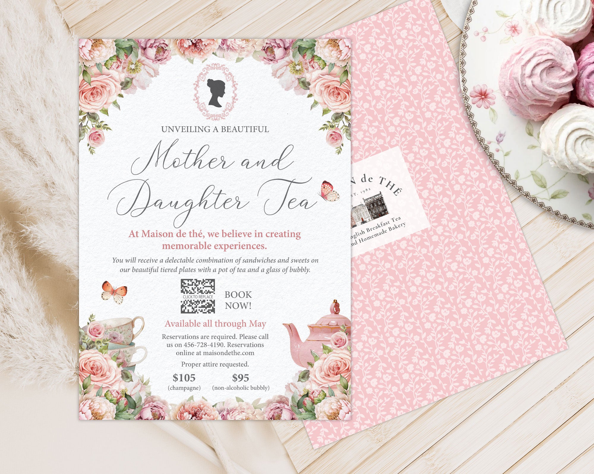 mother and daughter tea room event invitation with back and logo showing laying on a wooden background next to a plate of macarons