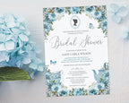 lovely dusty blue 5 x 7 regency style bridal shower invite laying on a grey background next to some blue hydrangeas