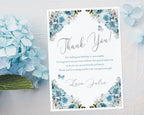 pretty blue flower thank you note laying on a white textured background next to a blue hydrangea