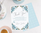 Pretty blue flower thank you note showing the blue pattern back on a white background next to a tea set