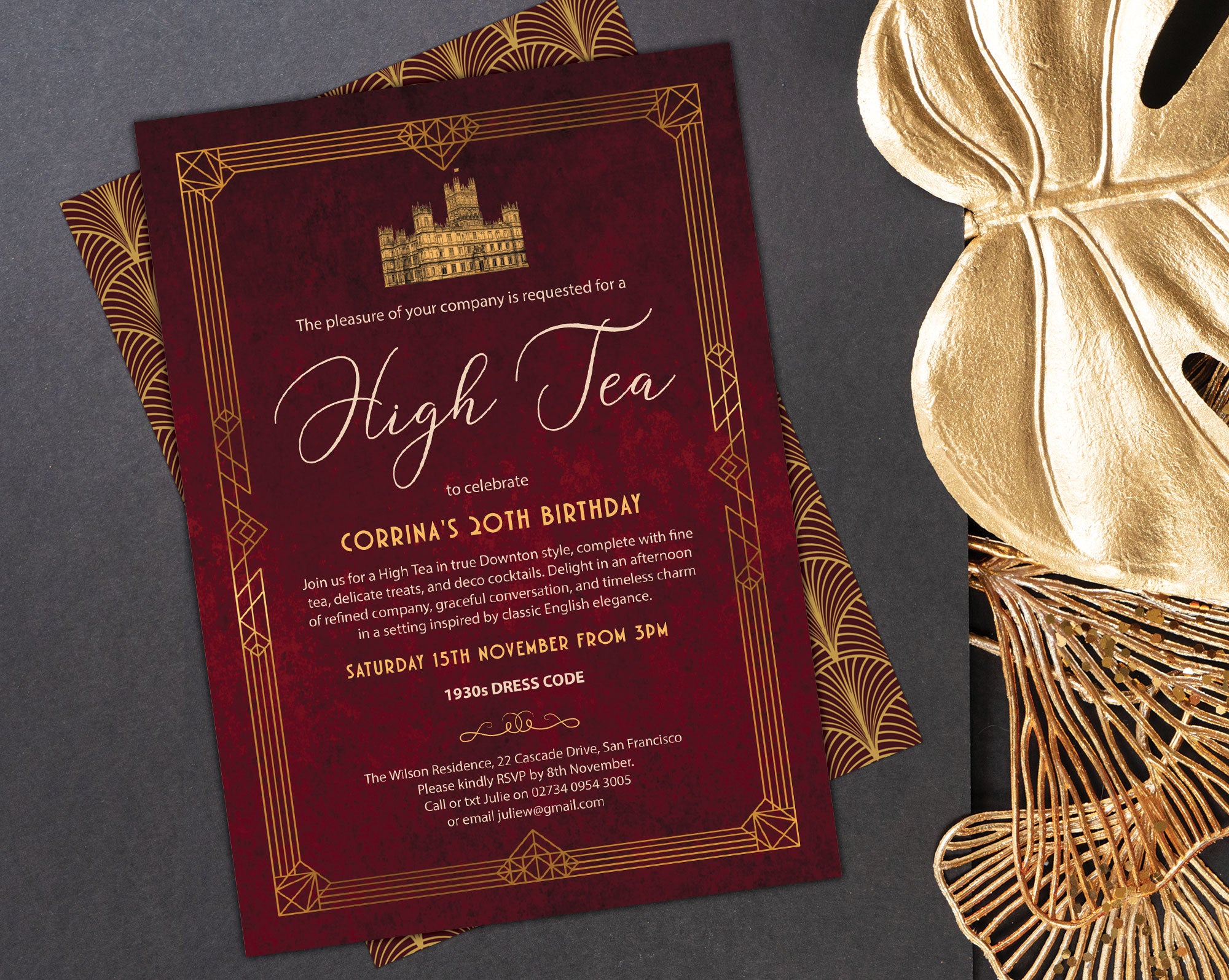elegant art deco high tea gold and burgundy invitation with gold and red pattern back on a dark grey background with gold leaf and decor