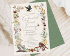 a recycled looking enchanted dinner invitation laying on a wooden surface, on top of another invitation showing the green pattern back