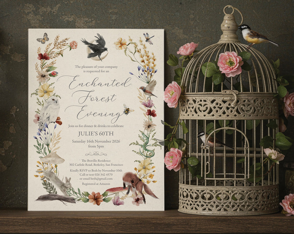 an elegant enchanted forest evening invitation with woodland animals and flora and fauna leaning up against a dark wall next to an ornamental birdcage filled with flowers and toy birds