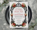 A black and red gothic high tea invitation with a cameo, teapot dragonfly and butterfly graphics laying on a black plate on a grey background