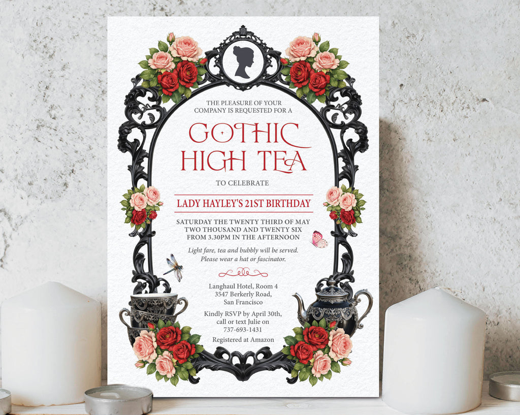 pretty gothic regency tea invitation with pink and red flowers, black ornate frame, teapot leaning up against a white concrete wall with two white candles either side