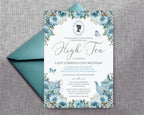 pretty dusty blue high tea flower invitation with cameo, teapot and butterflies laying on a blue envelope on a textured grey background