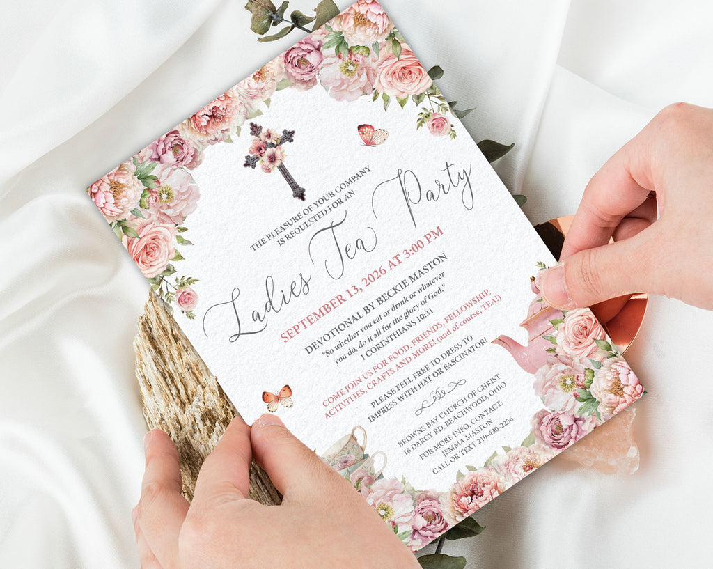 Floral church  tea party invitation held by hands on a white fabric background