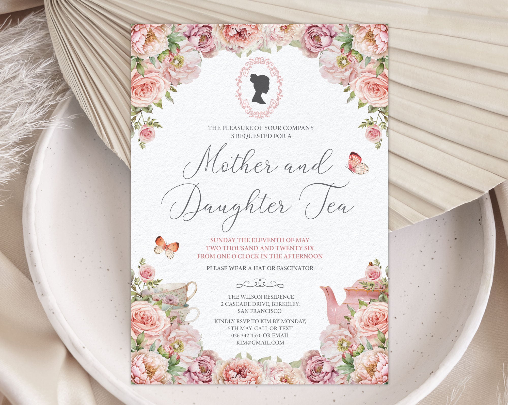 Invitation card for 'Mother and Daughter Tea' event with floral design on a textured surface.