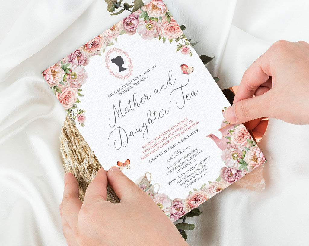 blush pink Floral mother and daughter tea invitation card held by hands on a white background