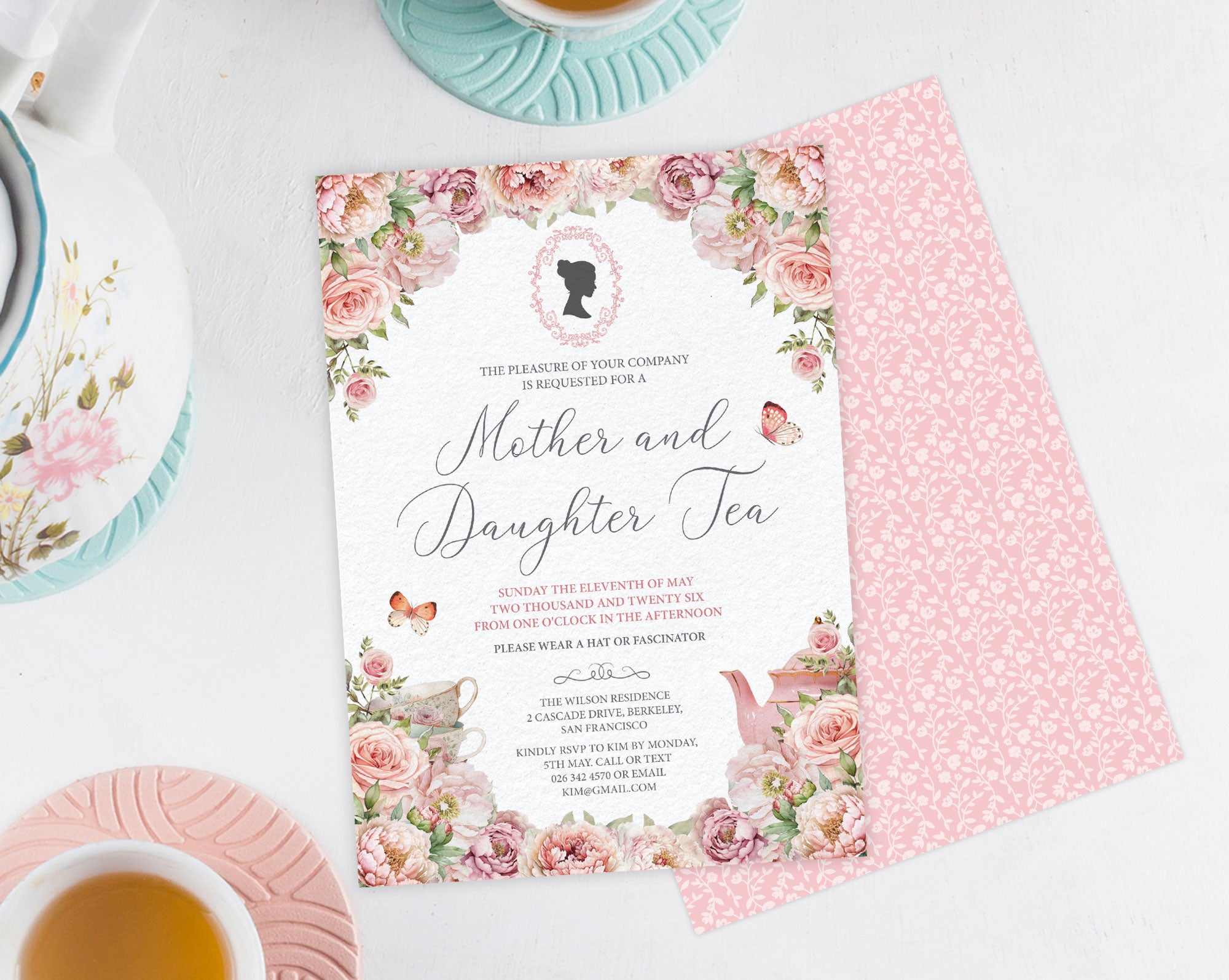 Floral invitation card for 'Mother and Daughter Tea' event on a white surface with tea cups and saucers.