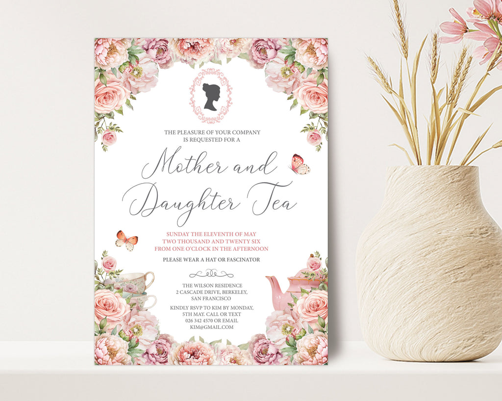 a 5 x 7 mother and daughter tea invitation standing up against a beige wall next to a vase of dried flowers