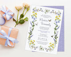 pretty purple and yellow wildflower bridal lunch invitation laying on a white background next to some yellow roses and 2 wrapped gifts