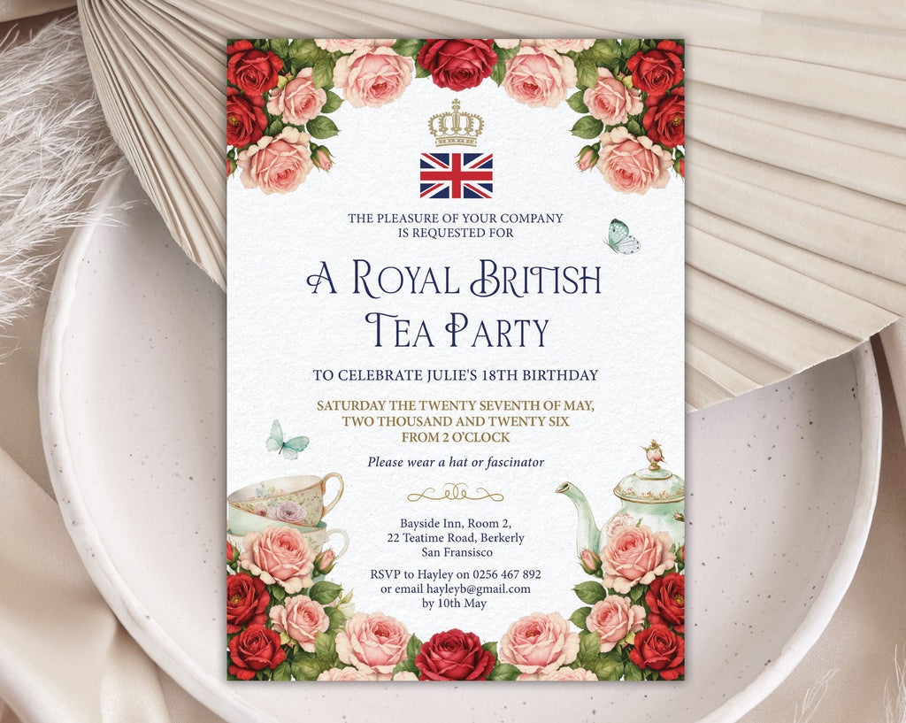 Invitation card for a Royal British Tea Party with red and pink roses, teapot, crown and flag logo and butterflies on a white plate with a dried leaf