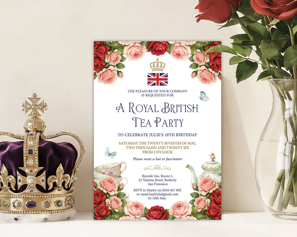 Royal British Tea Party invitation with floral design, crown, and British flag leaning up against a wall next to a royal crown and a jar of red roses