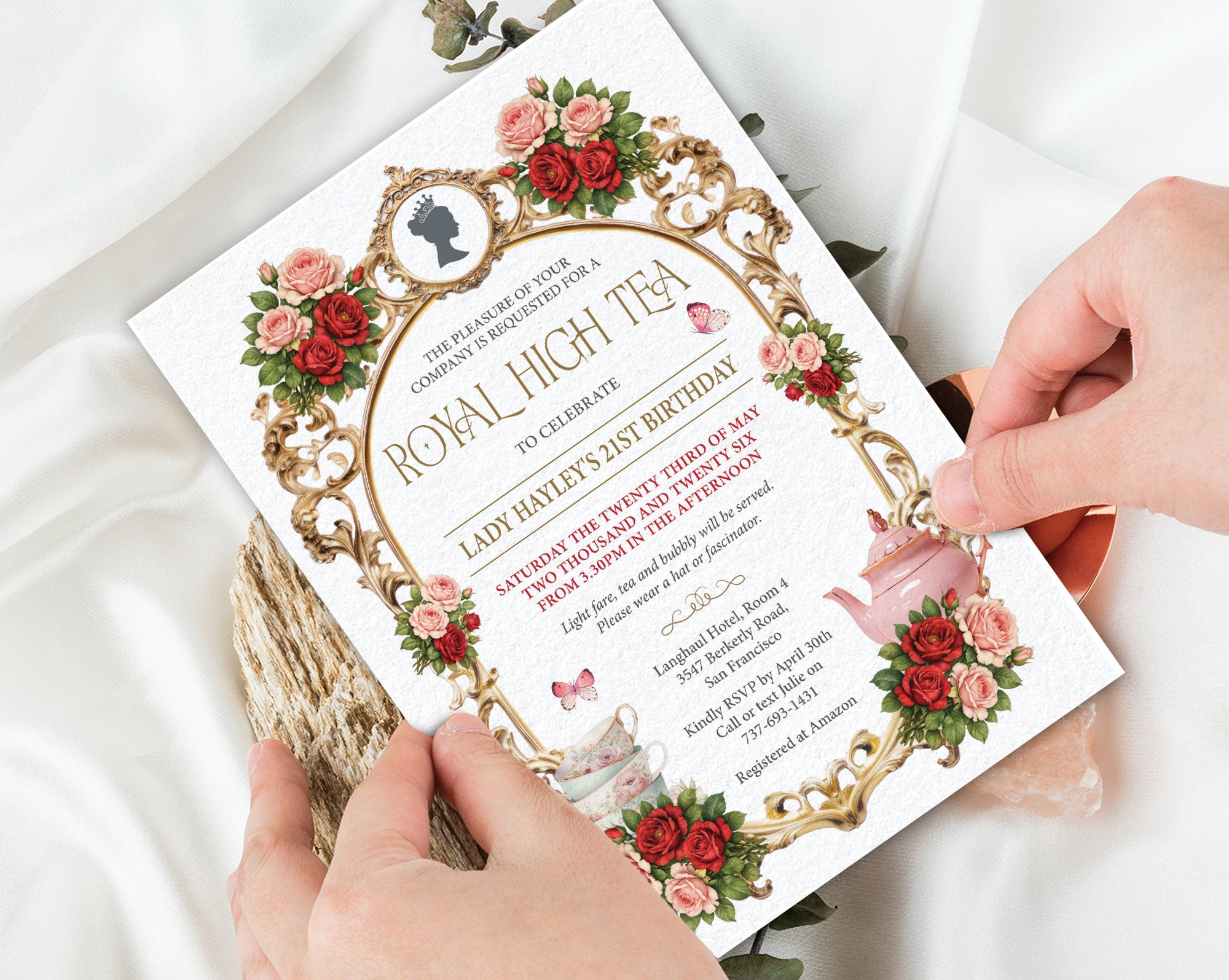 an elegant royal high tea invitation being held by two hands above a white background