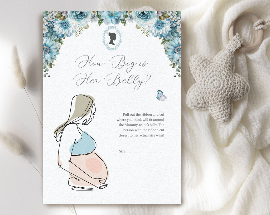 dusty blue flower baby shower game laying on a white cloth with a baby pacifier