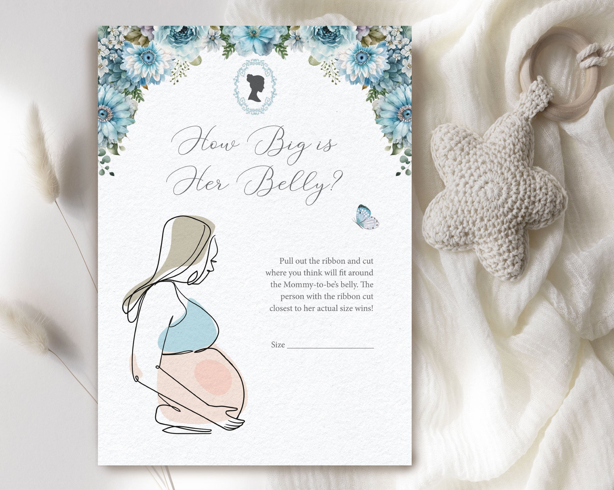 dusty blue flower baby shower game laying on a white cloth with a baby pacifier