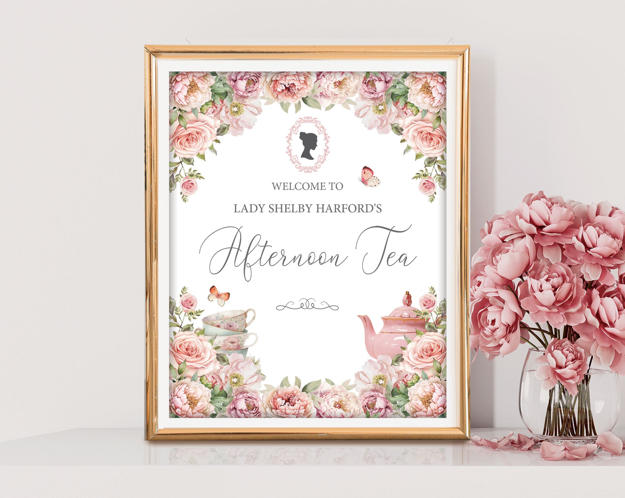 8x10, 12x18 Regency afternoon Tea Welcome Signs with Blush Pink flowers, Cameo, Butterflies in a gold frame leaning against a white wall next to some pink flowers